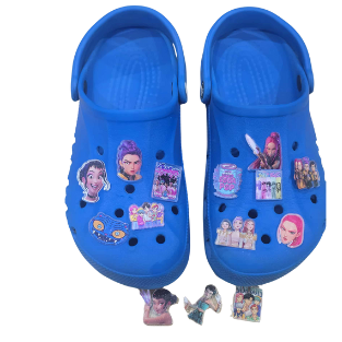 Blue clogs with colorful stickers on a white background