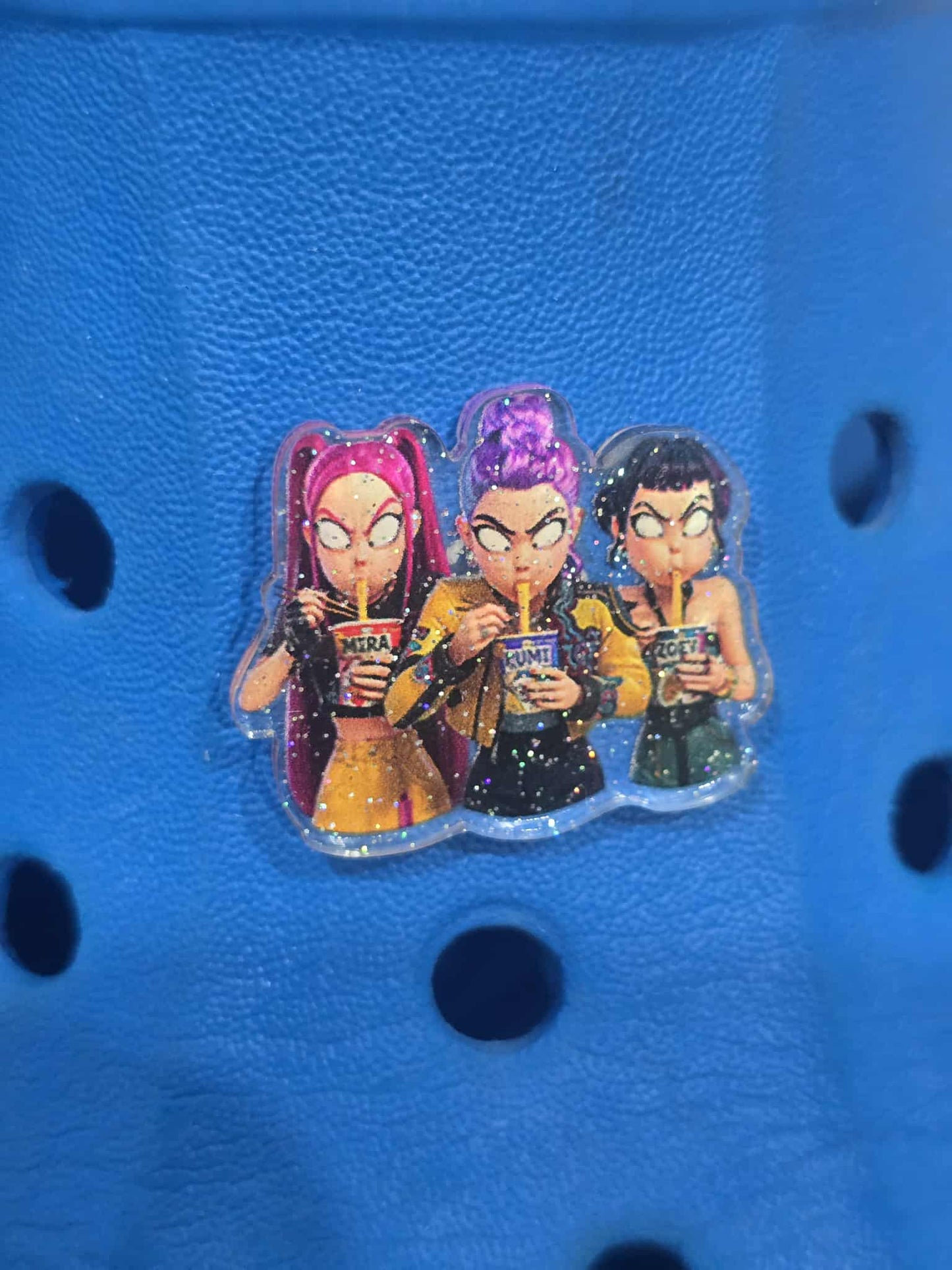 Three animated characters with colorful hair on a blue textured background