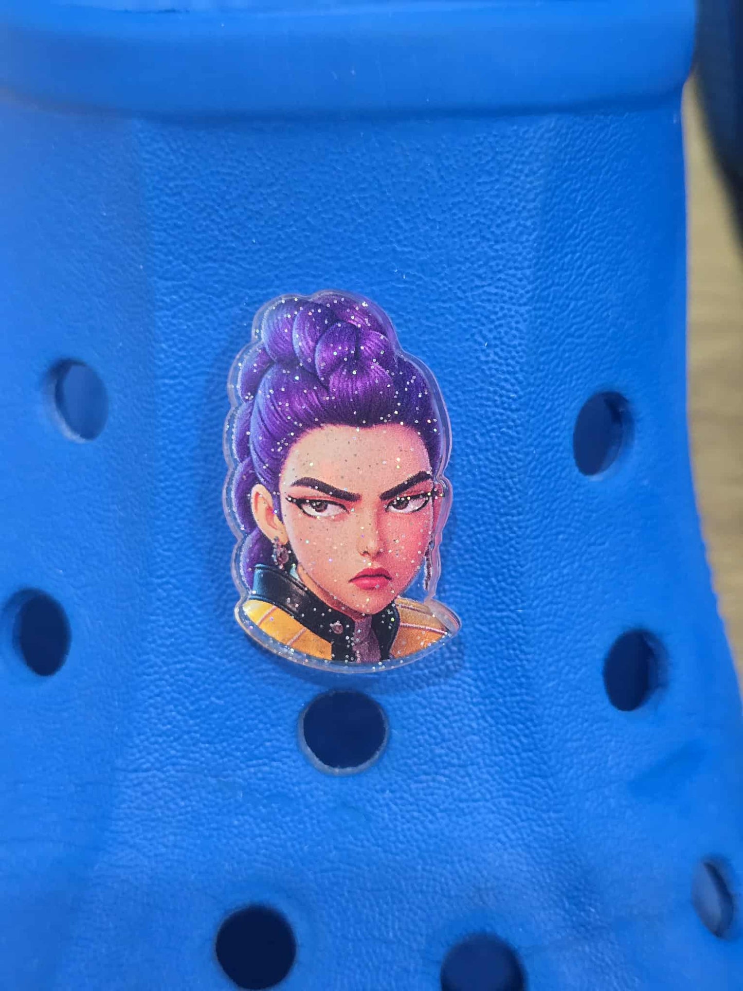 Blue shoe with a colorful character design on a blue background