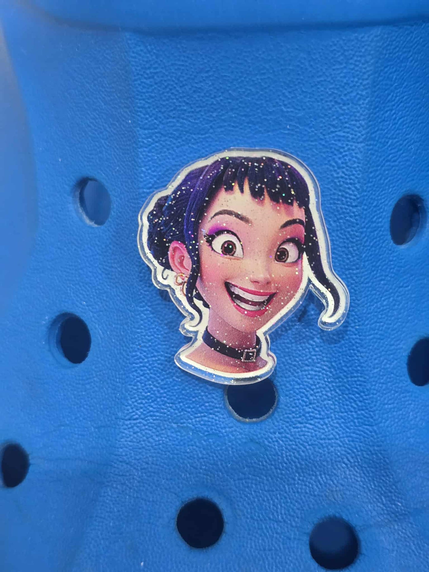 Blue shoe with a cartoon character sticker on a blue background