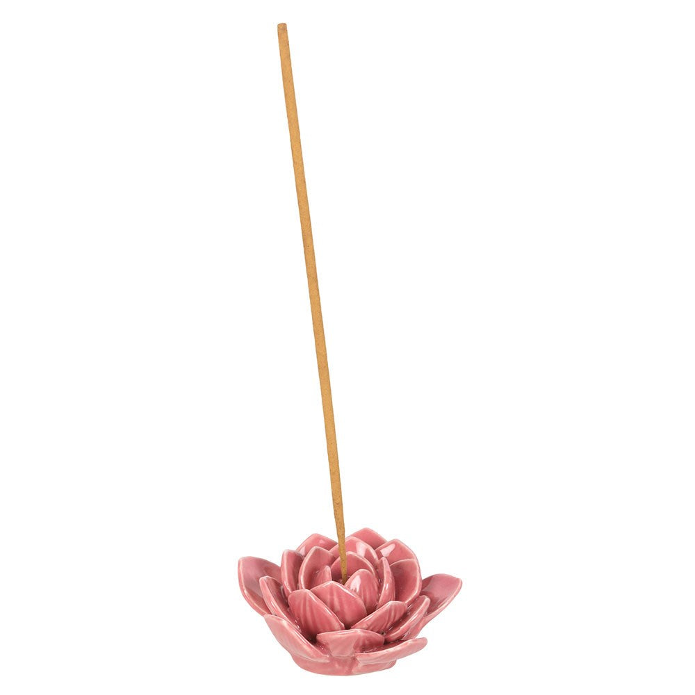 Pink lotus-shaped incense holder with a single incense stick on a white background