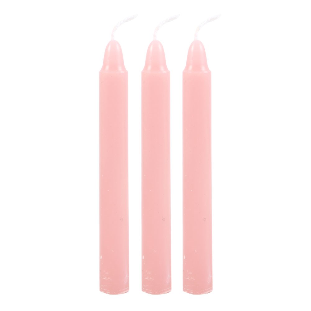Three pink candles on a white background